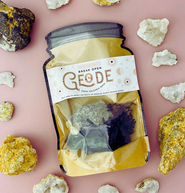 Break Open Geode in jar-shaped pack staged with other rocks and crystals on a pink surface