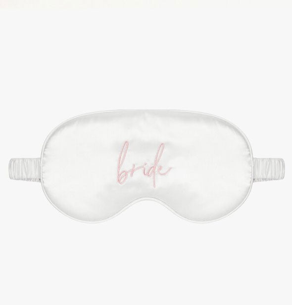 Shiny white satin sleep mask with ruched band and the word "Bride" embroidered in pink script on the front center
