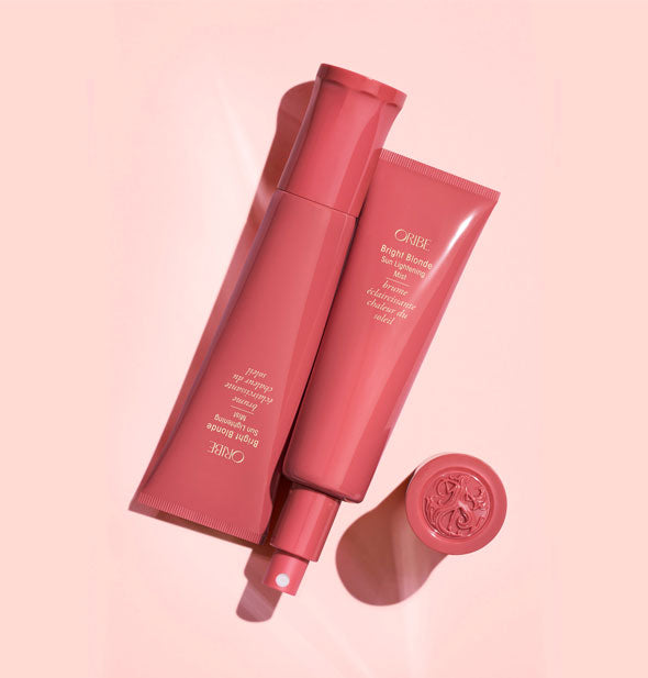 Oribe Bright Blonde Sun Lightening Mist bottles, one with cap removed to show nozzle