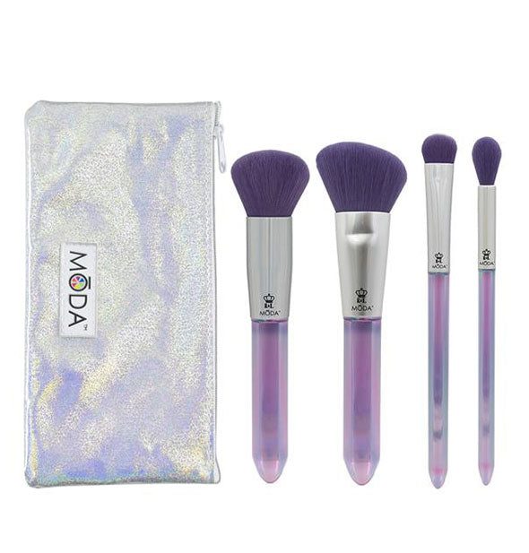 Set of four makeup brushes with purple bristles and crystal-shaped handles next to an iridescent storage pouch