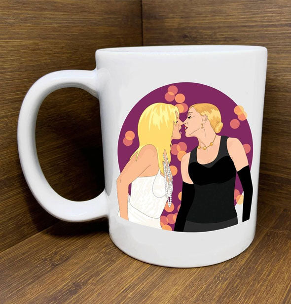 White mug with illustration of Britney Spears and Madonna kissing at the 2003 Video Music Awards