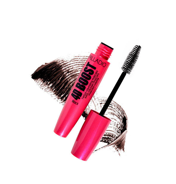 Hot pink tube of 4D Boost Palladio mascara with applicator removed and dark brown smudges of product drawn behind