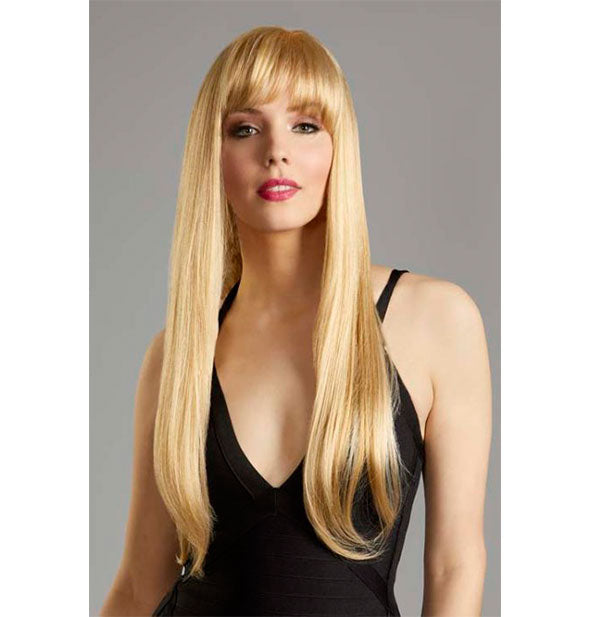 Model wearing a long, golden blonde wig with bangs.