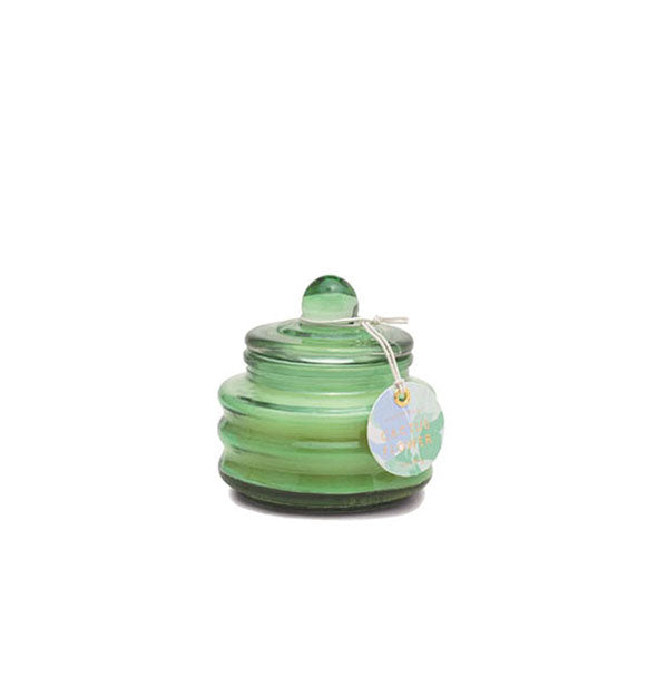 Small green ribbed glass candle jar with knobbed lid and tag attached