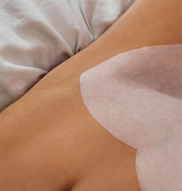 Model demonstrates placement of the Calming Bikini Mask on the pelvic region