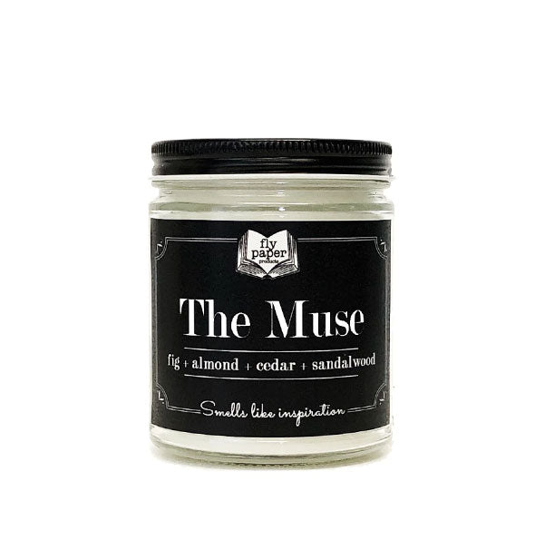 Glass jar candle with black lid and label that says, "The Muse: Fig + Almond + Cedar + Sandalwood: Smells like imagination"