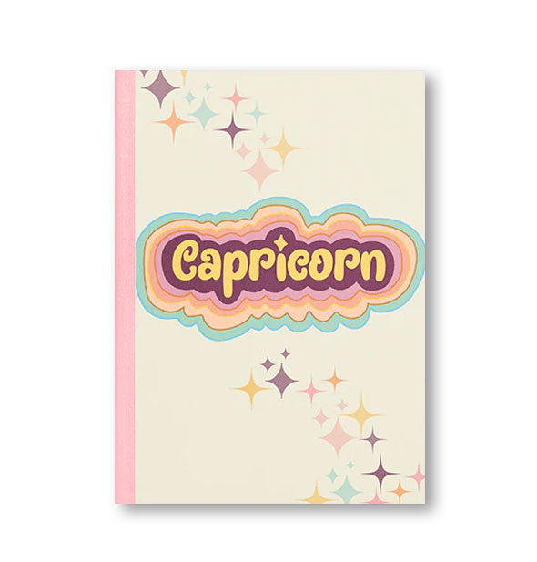 Notebook cover with pink binding, colorful stars, and colorful radiant lettering that reads, "Capricorn"