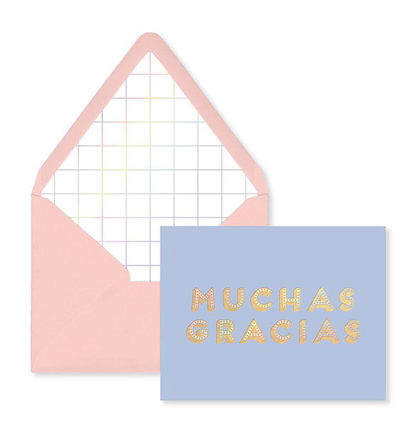 Periwinkle greeting card is printed with the words "Muchas Gracias" in gold and paired with a pink envelope.