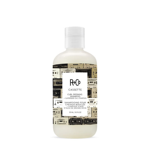 8.5 ounce bottle of R+Co Cassette Curl Defining Shampoo + Superseed Oil Complex