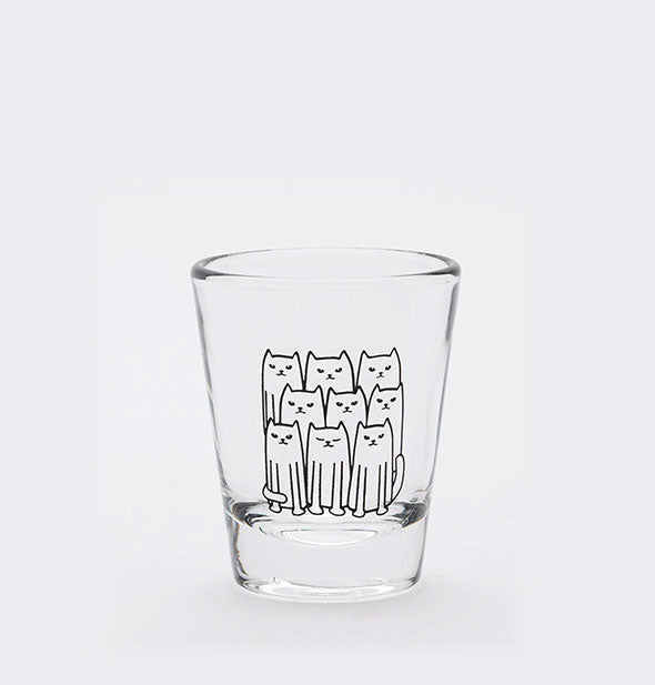 Clear shot glass with drawing of nine cats sitting side-by-side.