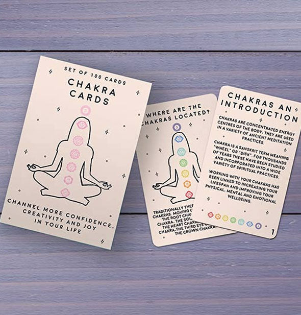 Sample cards from the Chakra Cards deck on a purple wooden surface