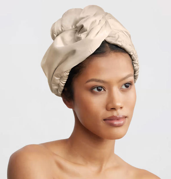 Model wears the Satin-Wrapped Microfiber Hair Towel by Kitsch in Champagne