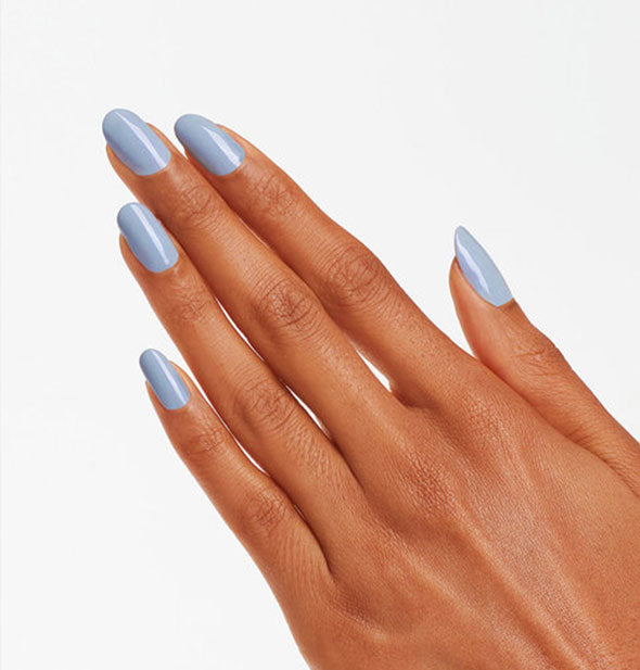 Model's hand wears a shade of silvery blue nail polish