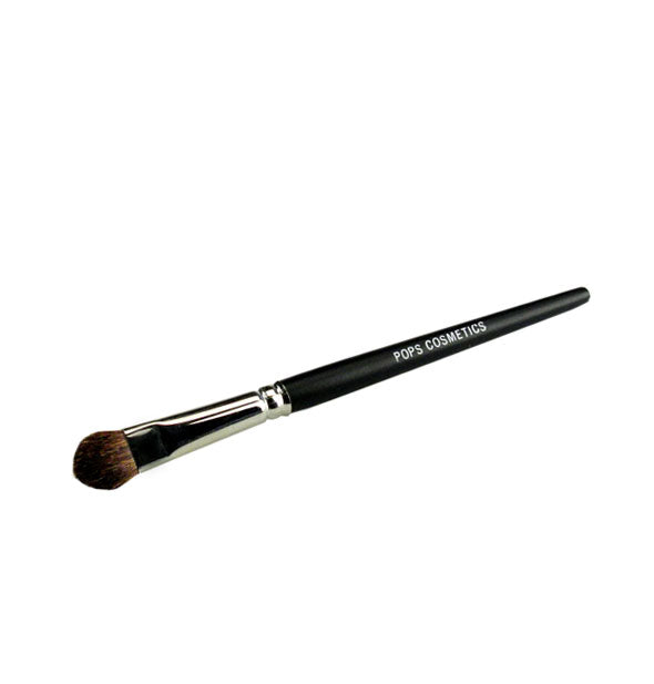 Rounded-tip Pops Cosmetics makeup brush with nickel ferrule and black handle