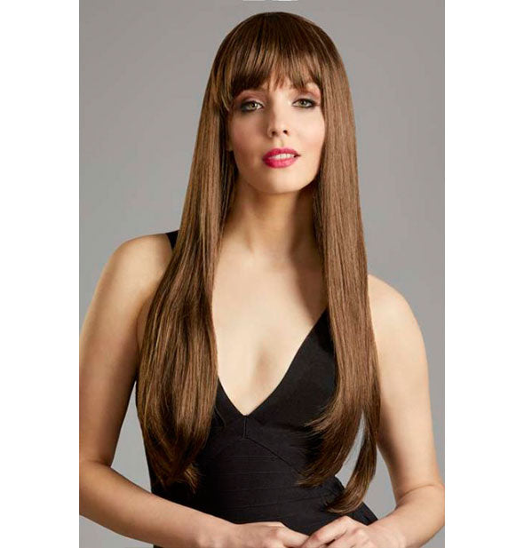 Model wearing a long, medium brown wig with bangs.
