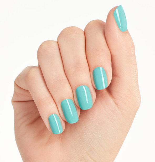 Model's hand wears a blue-green shade of nail polish
