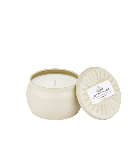 Mini cream-colored tin candle with embossed lid removed
