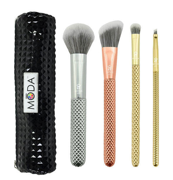 Set of four metallic makeup brushes with faceted handles next to a black studded Moda storage pouch