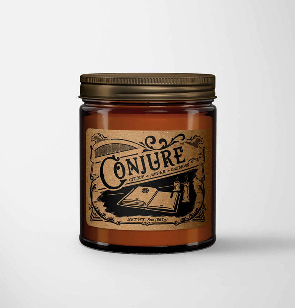 Conjure candle in amber glass jar with metal lid features a kraft paper label in a vintage style with book illustration
