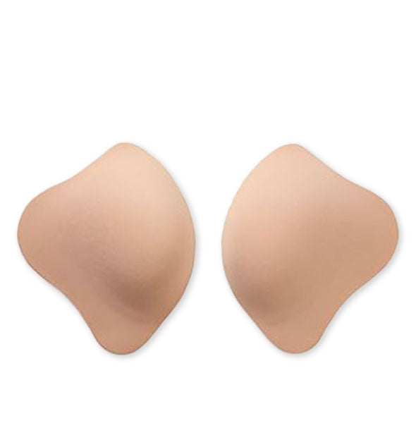Adhesive brassiere cups in light flesh tone