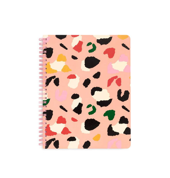 Light pink spiral-bound notebook cover with flecked leopard print pattern in black, white, red, green, and yellow