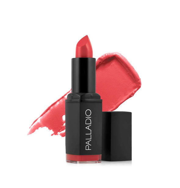 Black tube of Palladio lipstick with cap removed and color swatch behind in a light pinkish-red shade called Coral