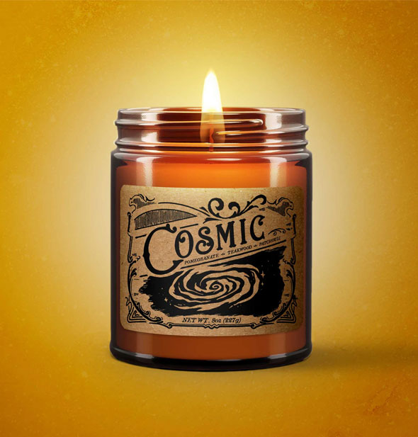Lit Cosmic candle on yellow backdrop