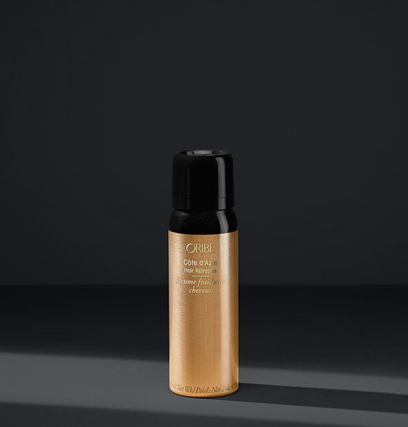 Black and gold can of Oribe Côte d'Azur Hair Refresher on dark gray background