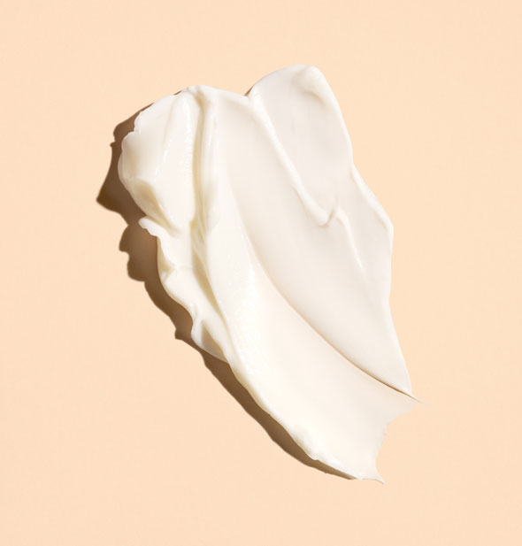 Sample application of white, creamy Oribe Côte d'Azur Restorative Body Crème