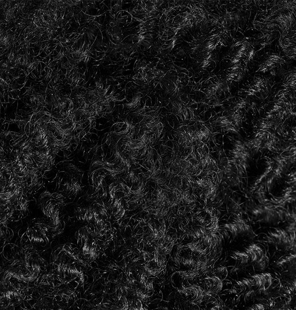 Closeup of hair with a very tight curl pattern after using Oribe's Curl Gelée for Shine & Definition