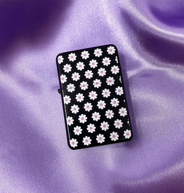 Black rectangular lighter with all-over daisies print on purple satin cloth