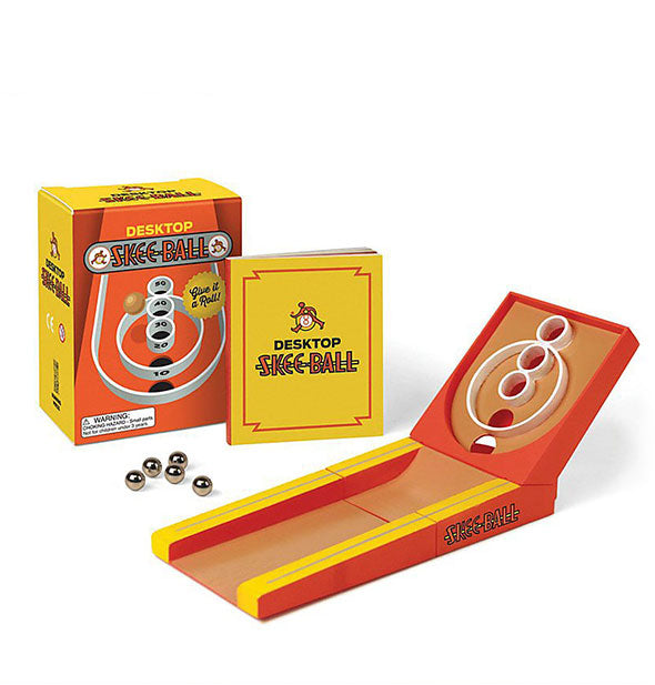 Contents of the Desktop Skee-Ball Kit: five mini silver balls, mini lane, and booklet with box