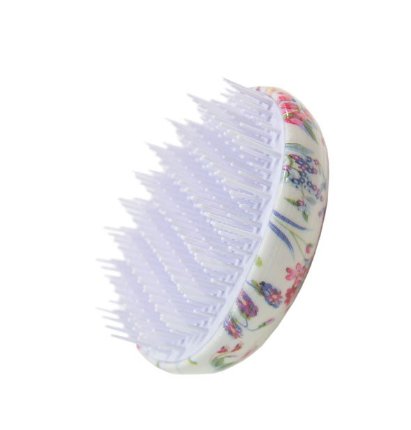 Handle-less egg-shaped floral print hair brush with white bristles