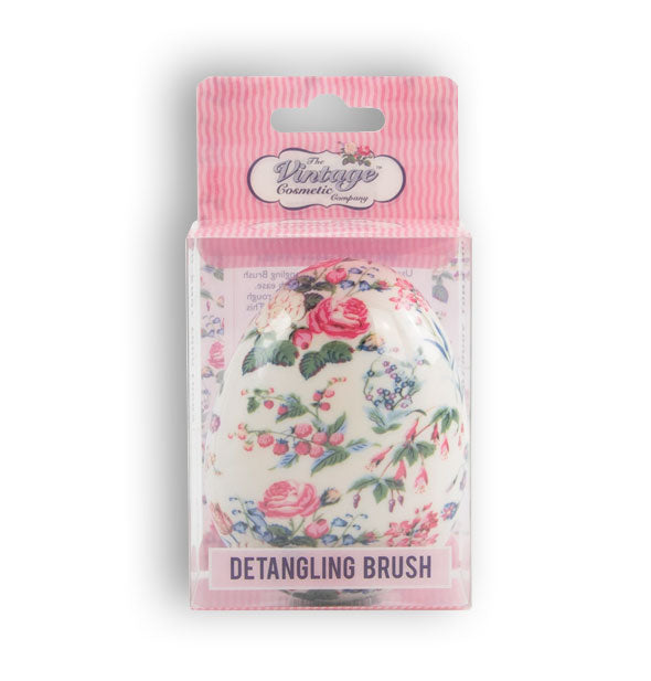 Floral print egg-shaped detangling hairbrush by The Vintage Cosmetic Company in pink striped packaging