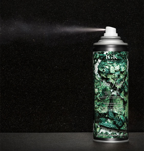 An application of IGK Direct Flight Multi-Tasking Matcha Dry Shampoo is dispensed from can