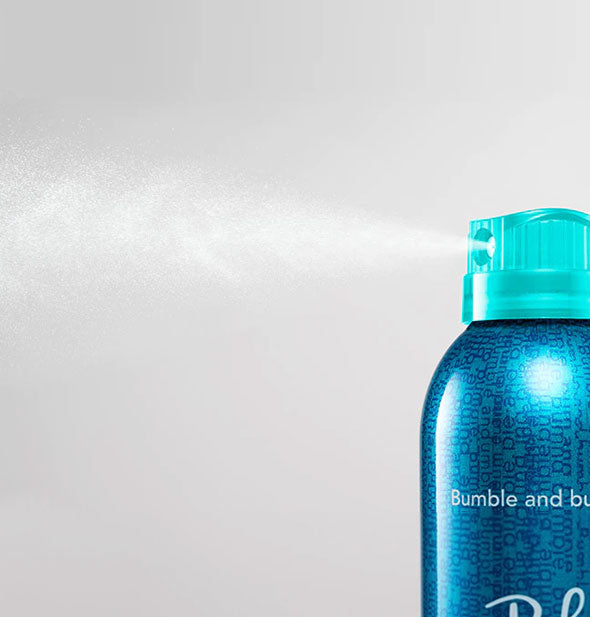 A  fine mist is dispensed from a can of Bumble and bumble Does It All Light Hold Hairspray