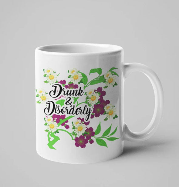 White coffee mug with floral illustration says, "Drunk & Disorderly"