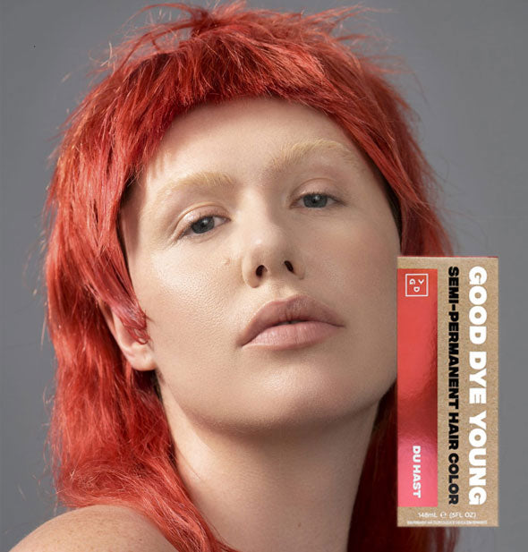 Model with pastel red-orange hair color by Good Dye Young in the shade Du Hast