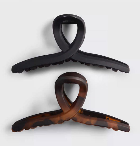 Two loop shape claw clips, one black and one brown tortoise