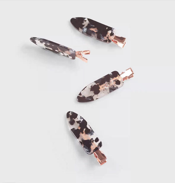 Four terrazzo-effect hair clips with rose gold hardware
