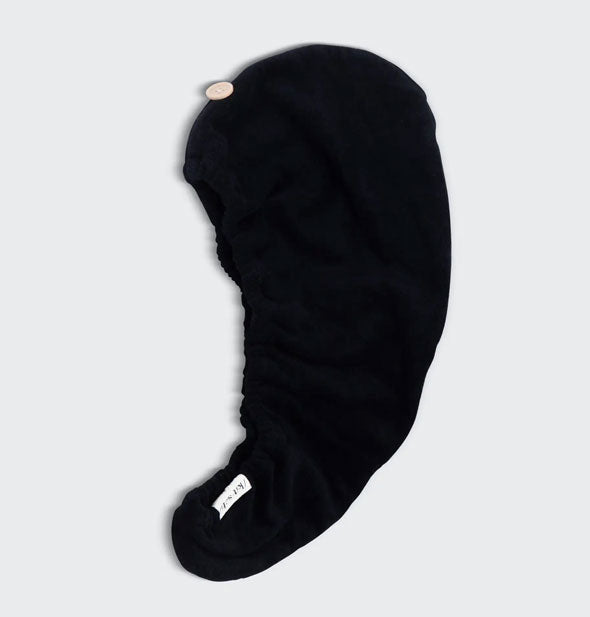 Eco-Friendly Black hair towel wrap by Kitsch lays flat to show button closure and elastic opening