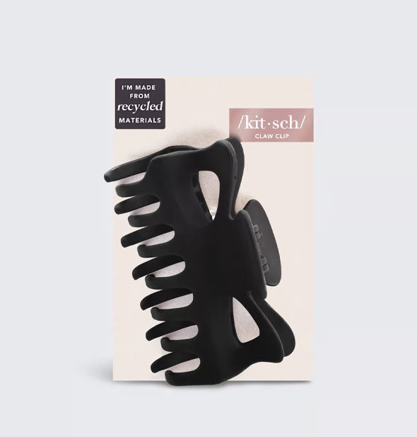 Large matte black hair claw clip on light pink Kitsch product card is labeled, "I'm made from recycled materials"