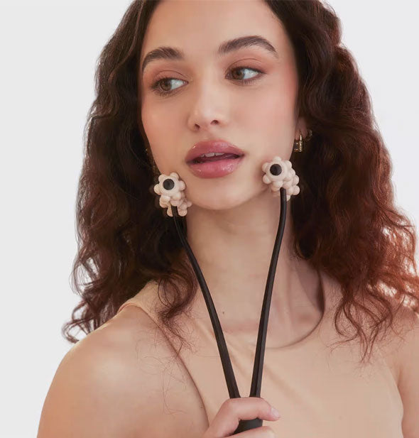 Model uses the Lifting Facial Roller on jawline