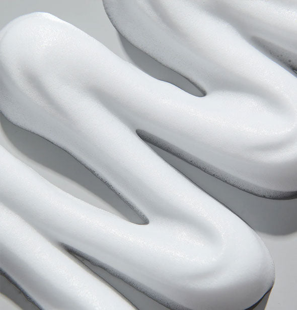 Closeup of a squiggle of white Unite ELEVATE MOUSSE