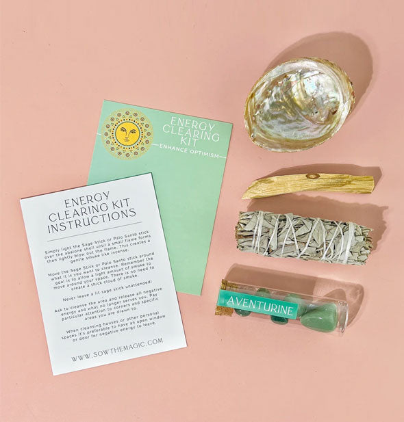 Contents of the Energy Clearing Kit include abalone shell, palo santo stick, sage bundle, aventurine stones vial, and instruction sheet
