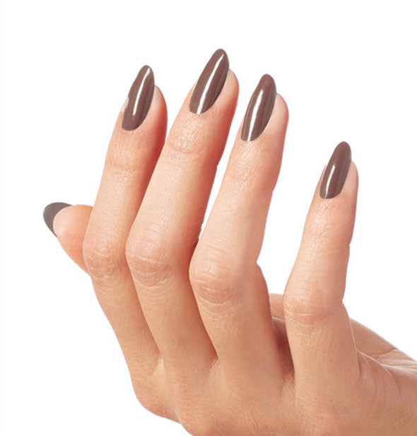 Model's hand wears brown nail polish