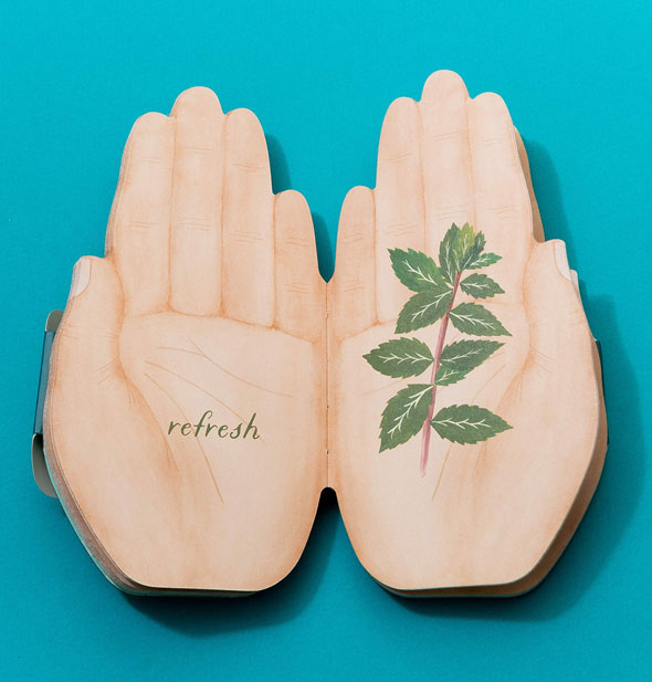 Open hands book is open to a page spread with leaves and the word, "Refresh"