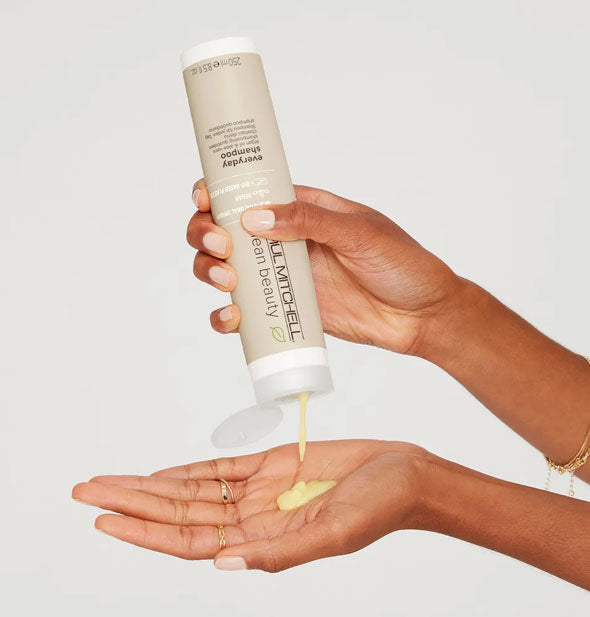 Model pours Paul Mitchell Clean Beauty Everyday Shampoo from bottle into hand