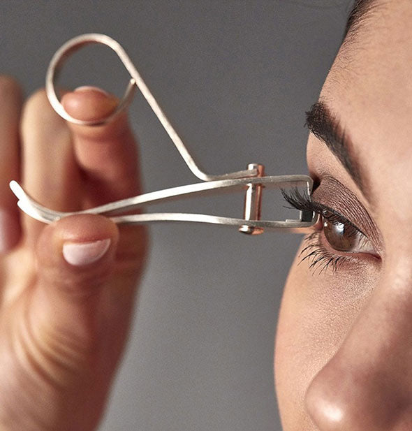 Model demonstrates use of the Every Lash eyelash curler