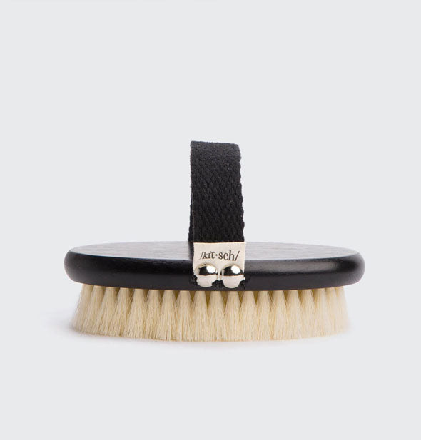 Kitsch body brush with black paddle, handle, and natural bristles